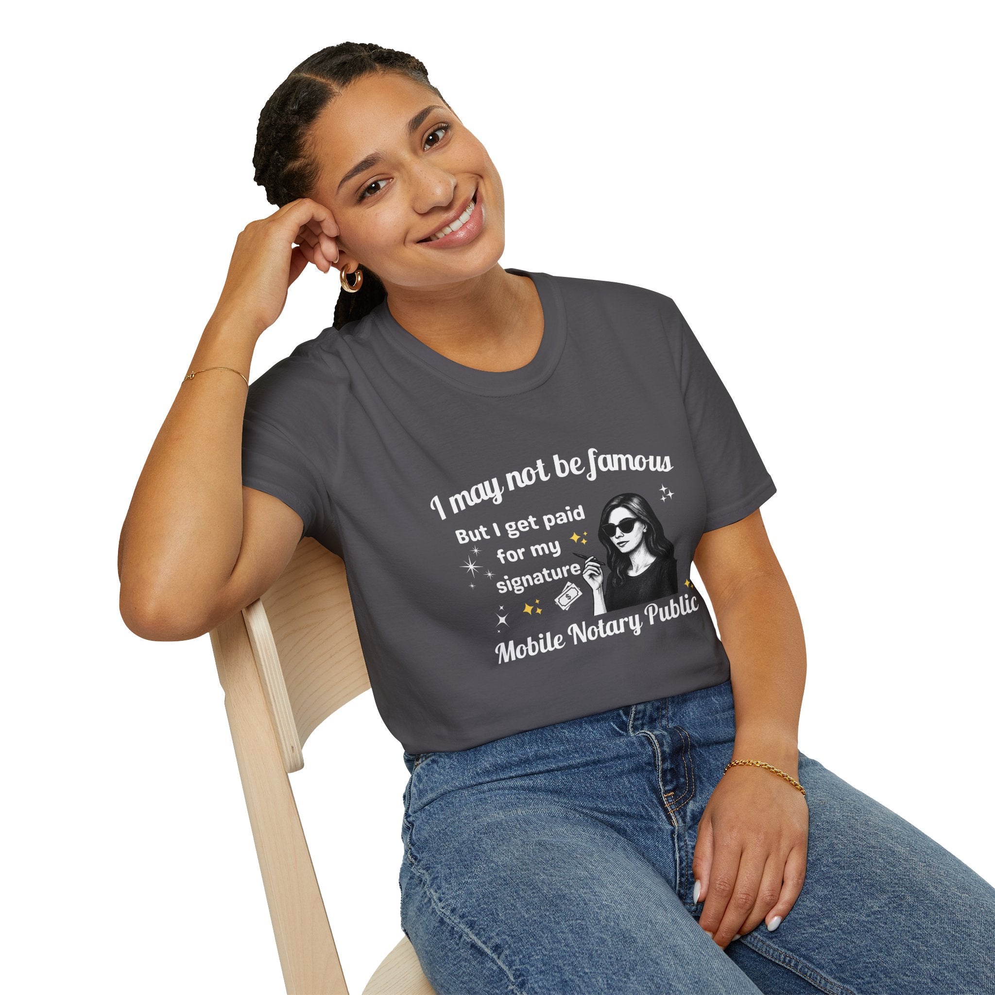 Person wearing a t-shirt with a frog graphic and text, sitting on a chair.