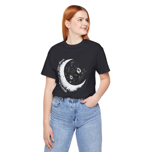 Person wearing a black t-shirt with a celestial design and blue jeans on a white background