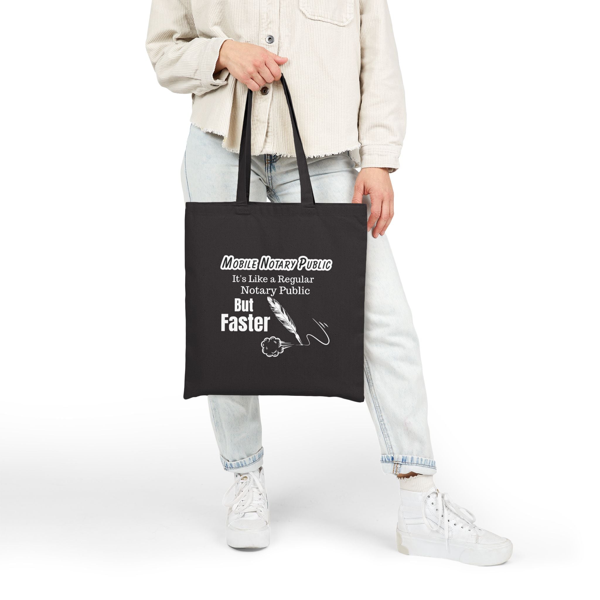 Person holding a black tote bag with humorous text design on a white background