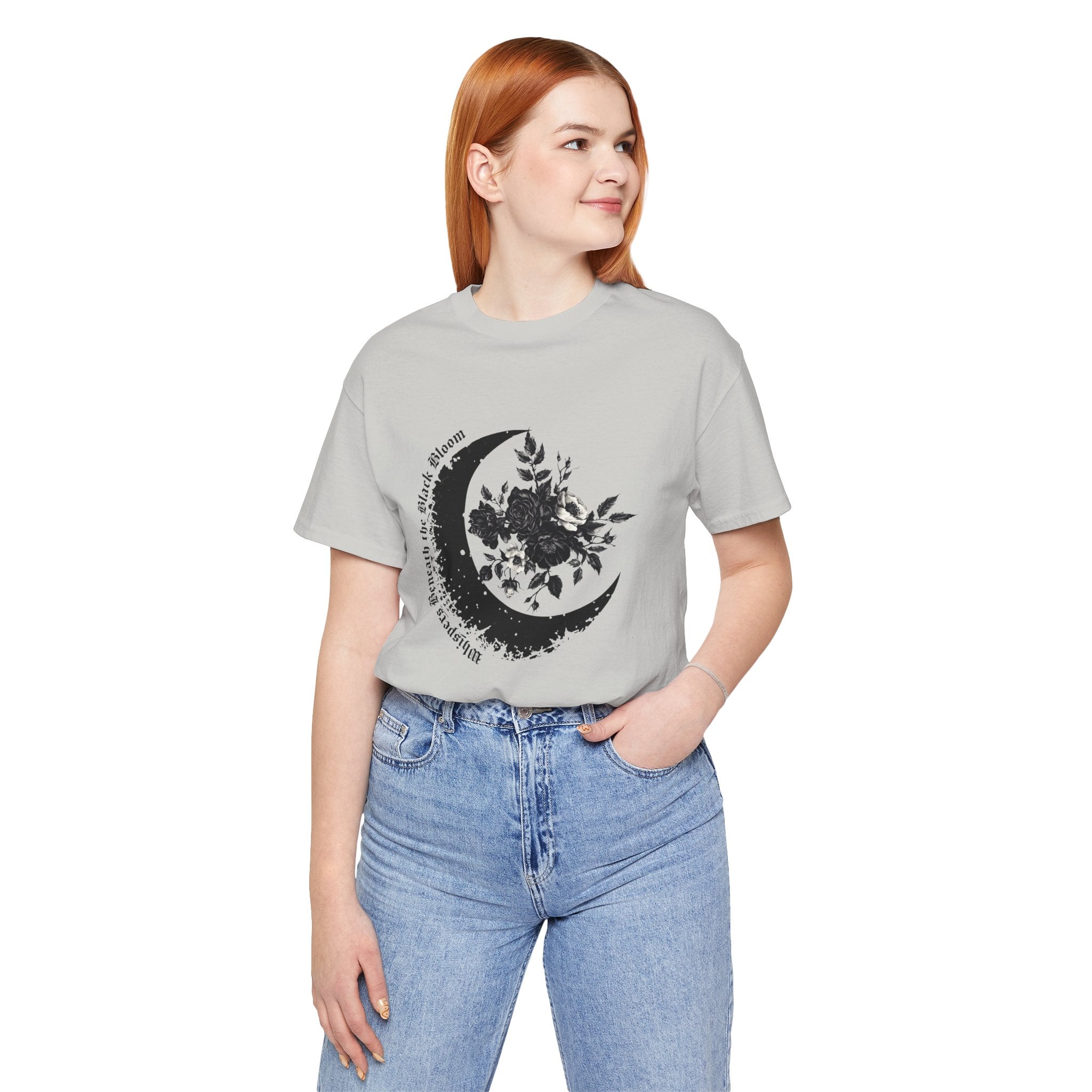 Person wearing a gray t-shirt with a black moon and leaf design on a white background