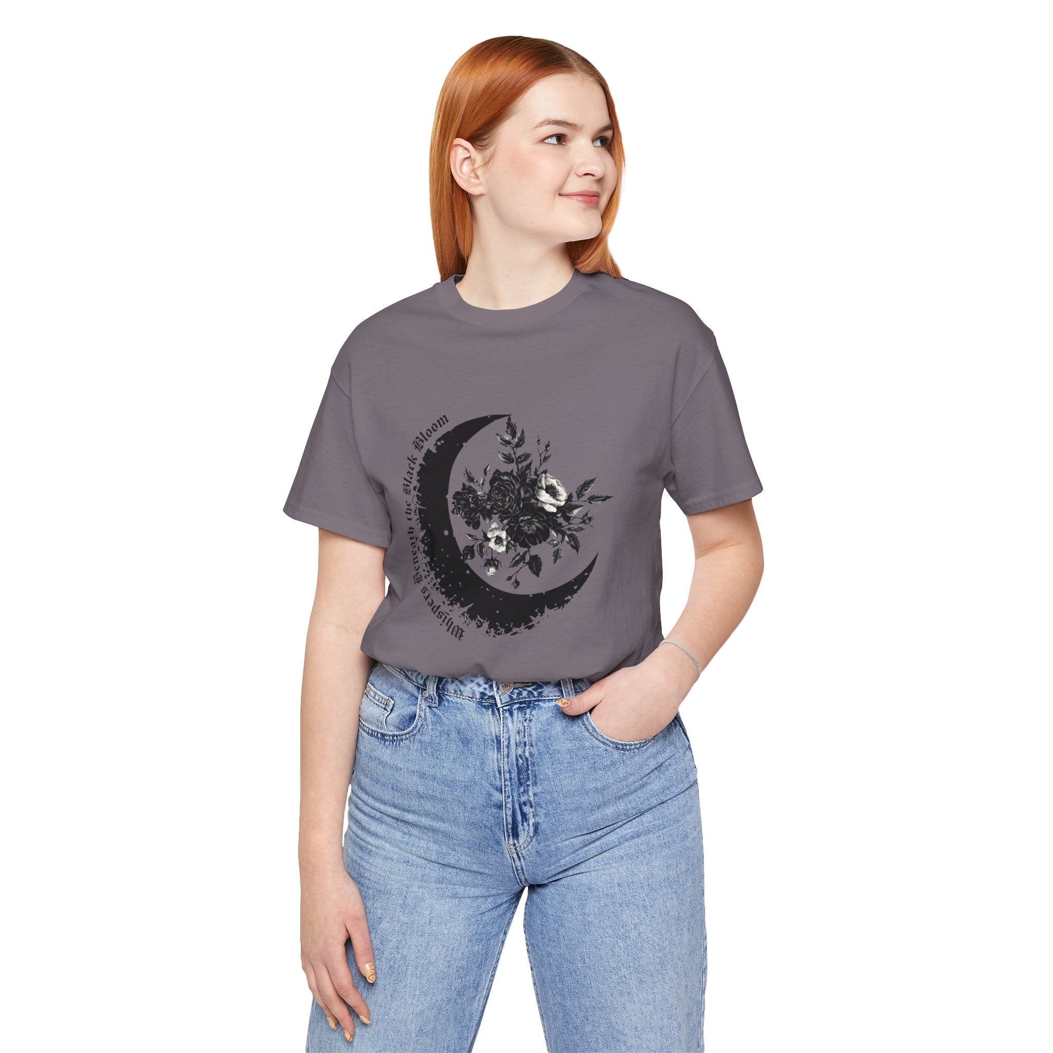 Person wearing a gray t-shirt with a black moon and floral design on a white background