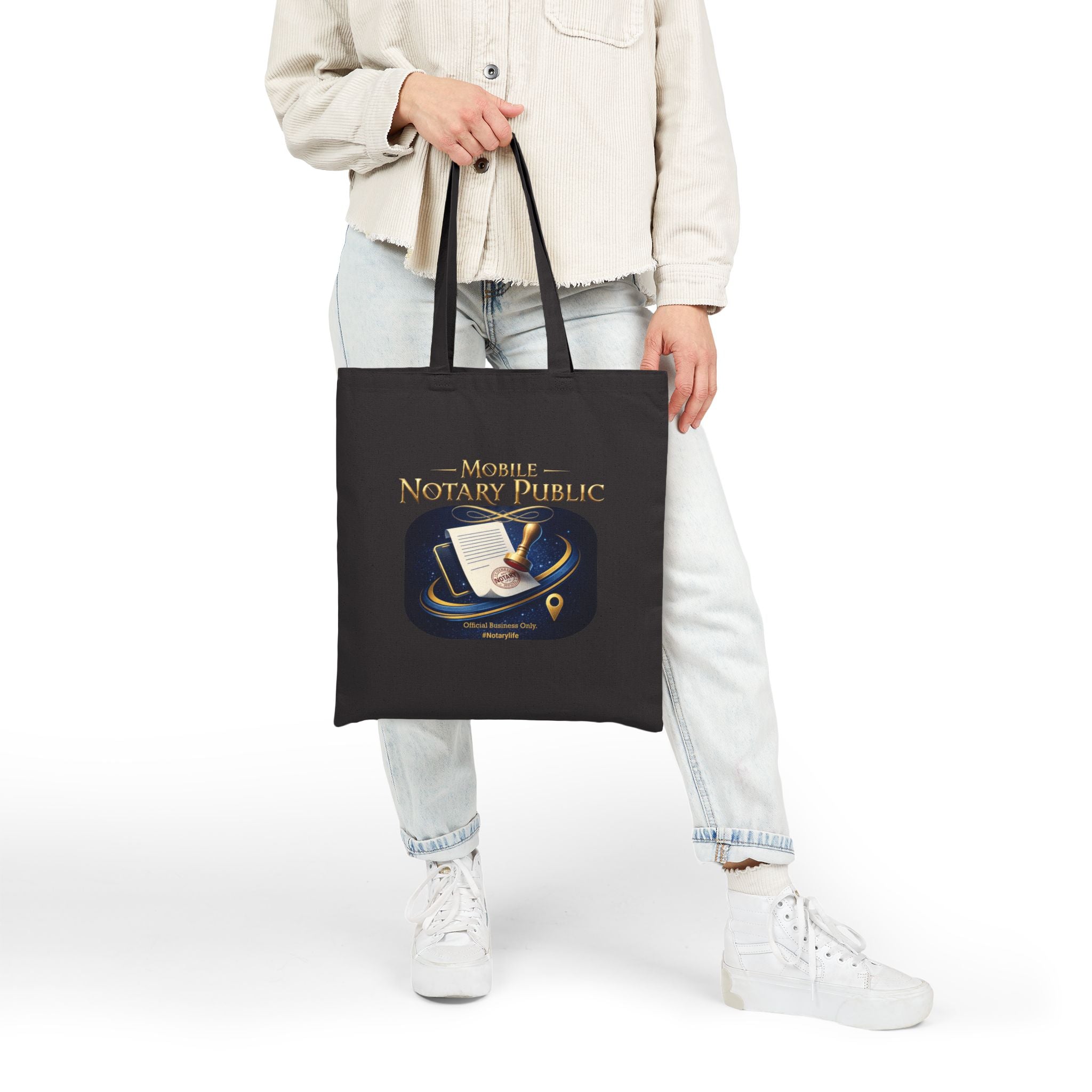 Person holding a black tote bag with humorous text design on a white background