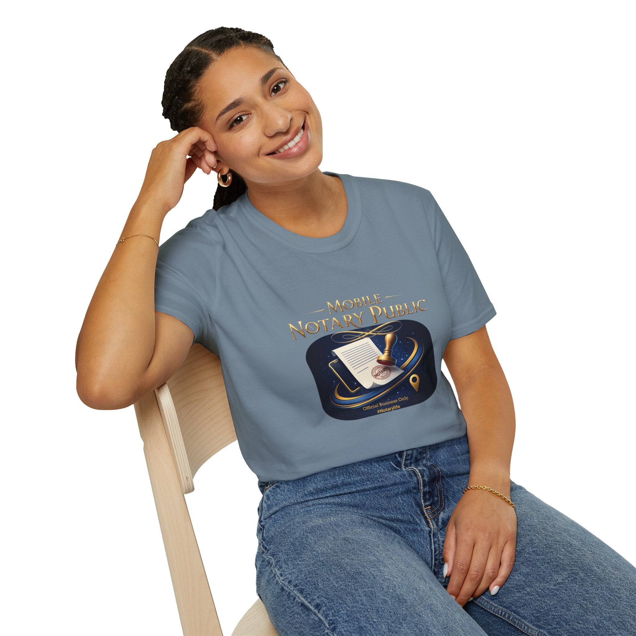 Woman wearing a blue t-shirt with a graphic design, sitting on a white background