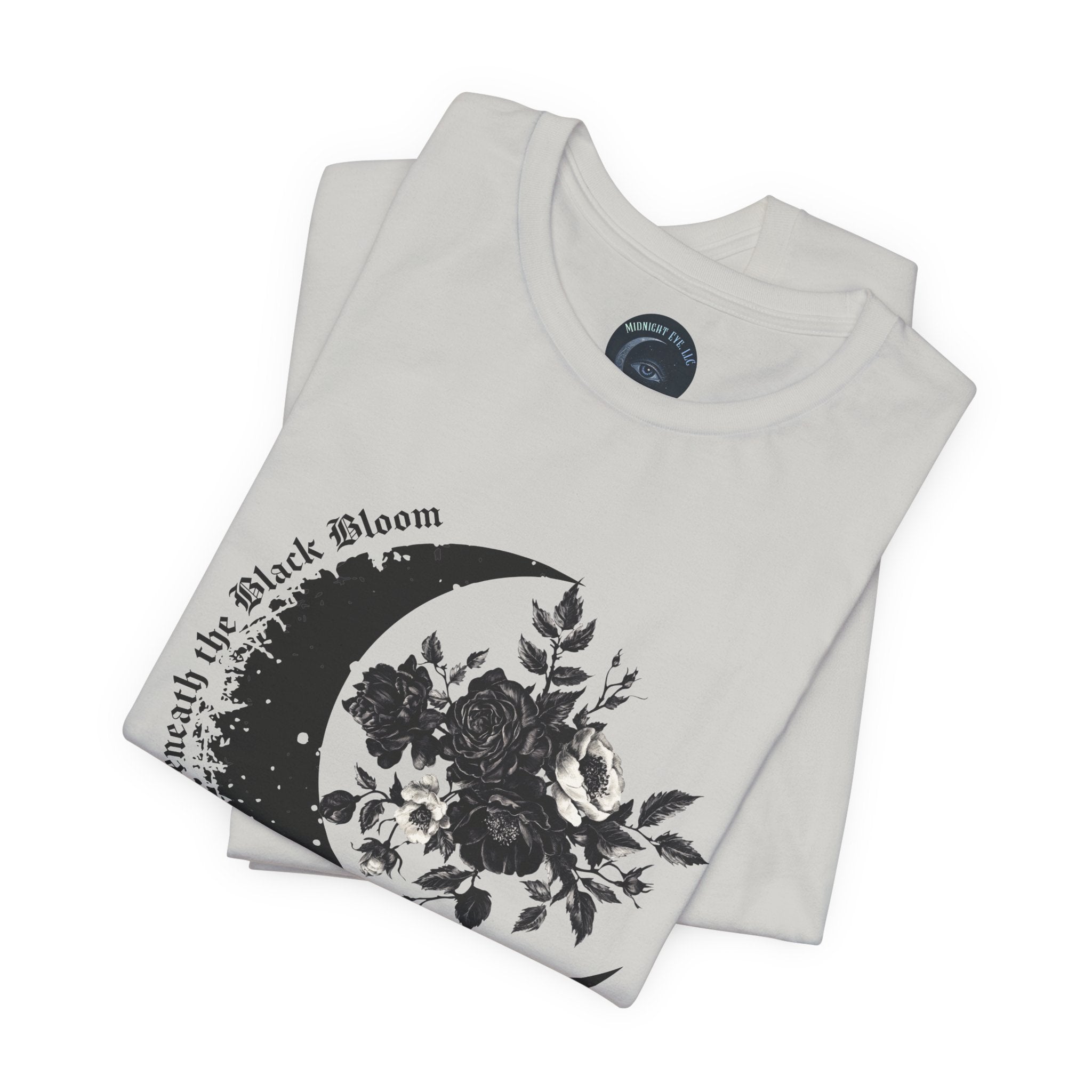 Folded white t-shirt with black floral design and text on a white background