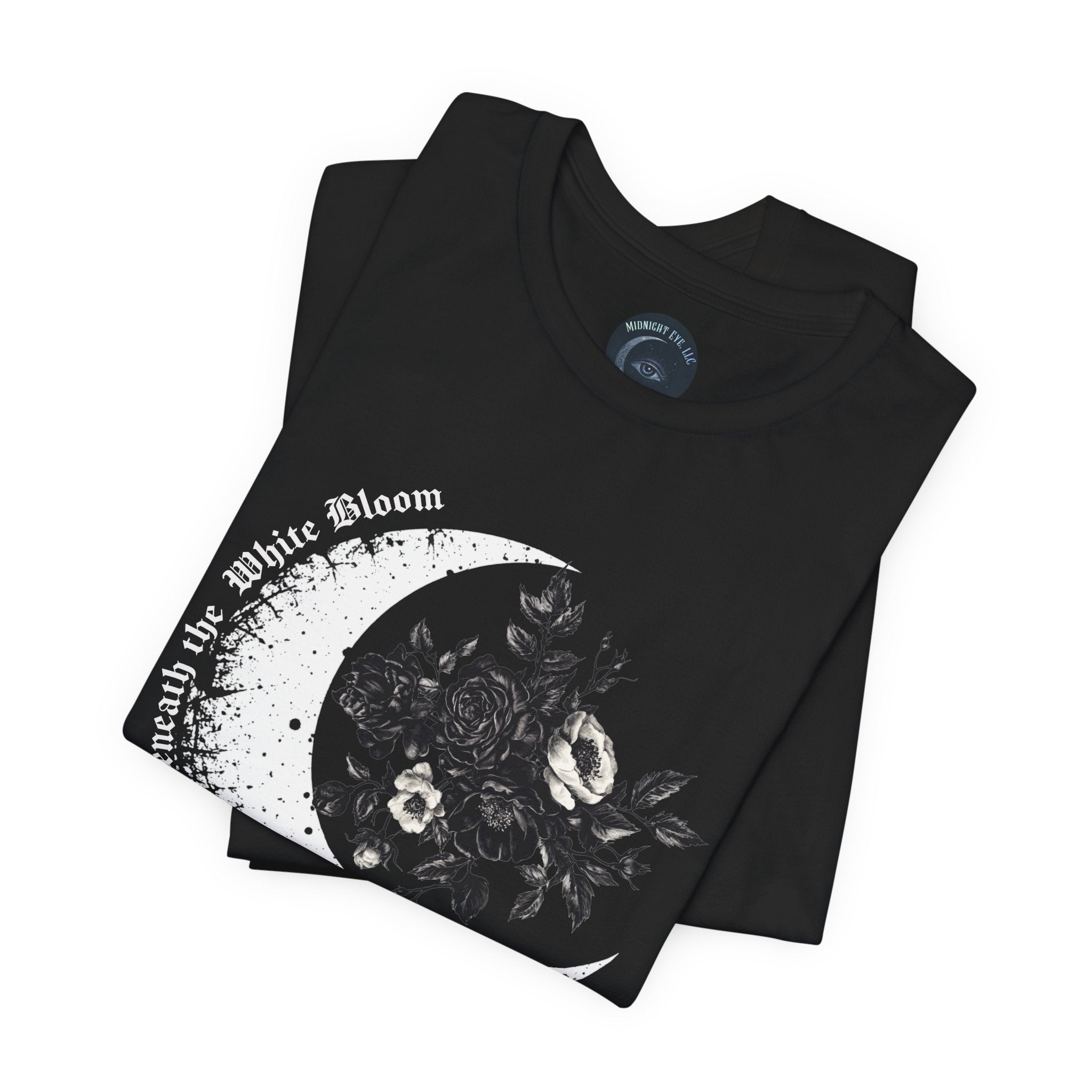Black t-shirt with floral crescent moon design and text on a white background
