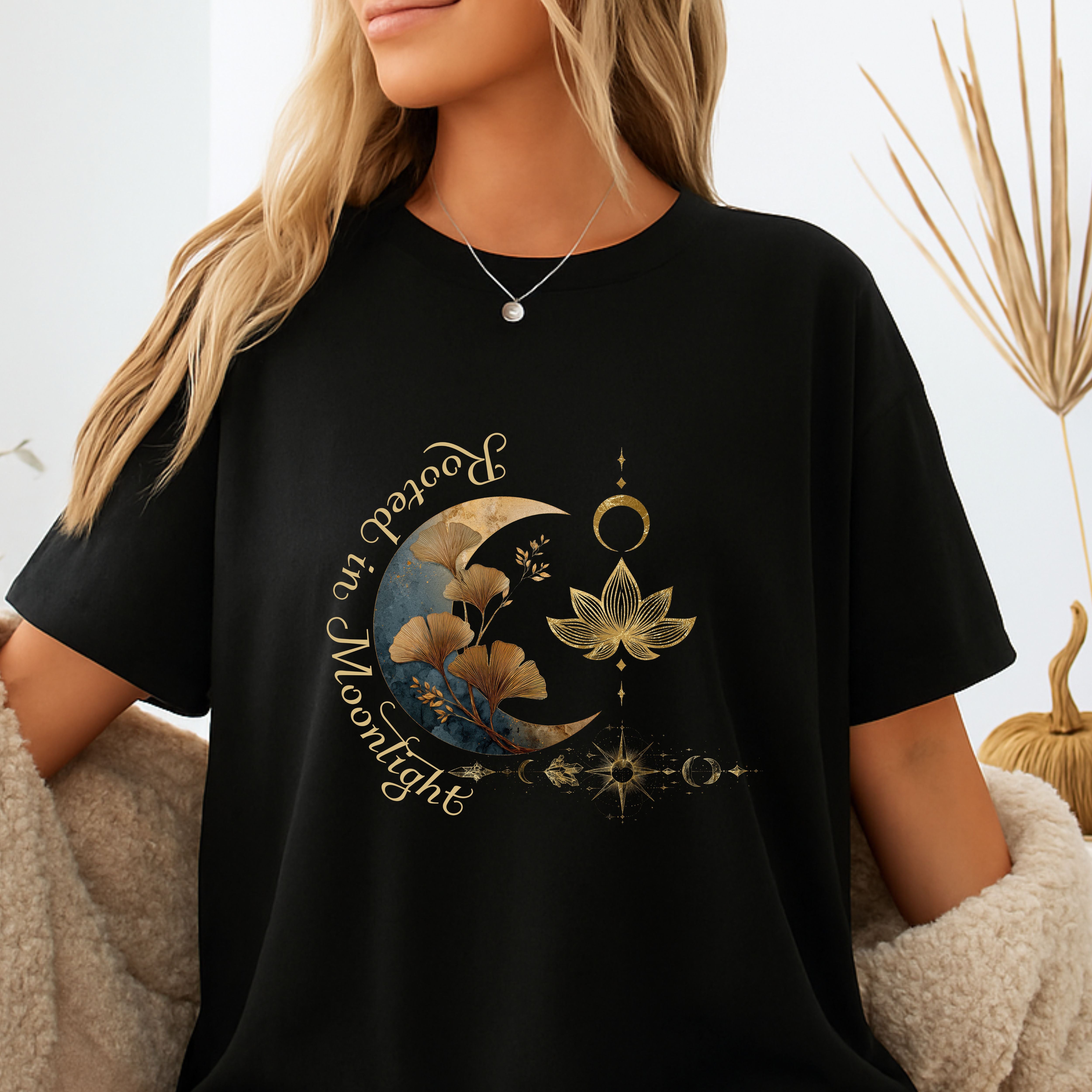 Black t-shirt with a celestial design and text.