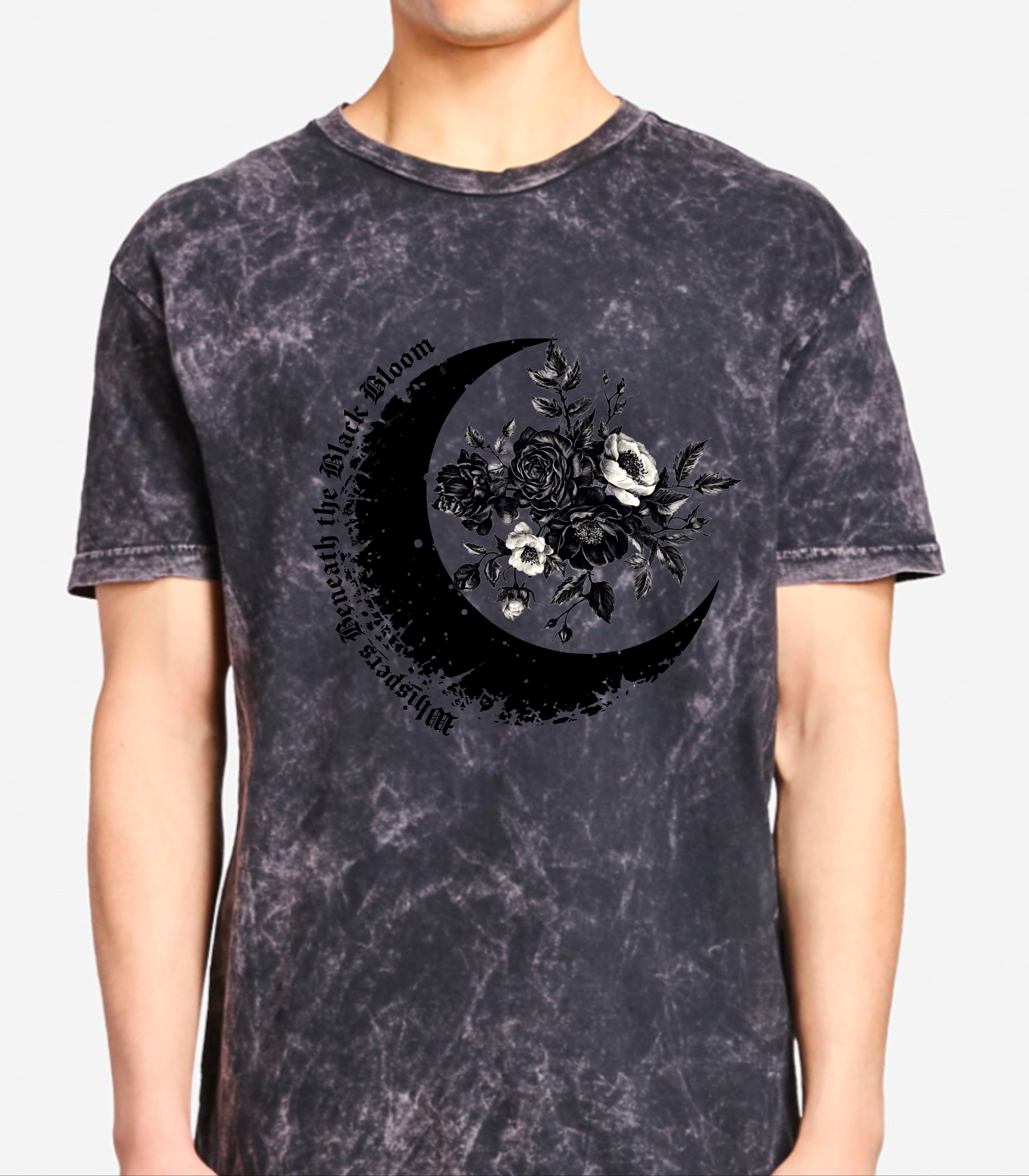 Person wearing a black acid-wash t-shirt with a floral crescent moon design.